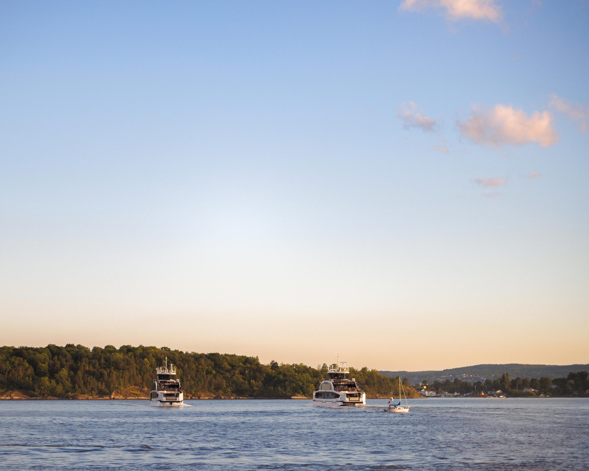 Two Ruter island ferries on the sea at sunset.