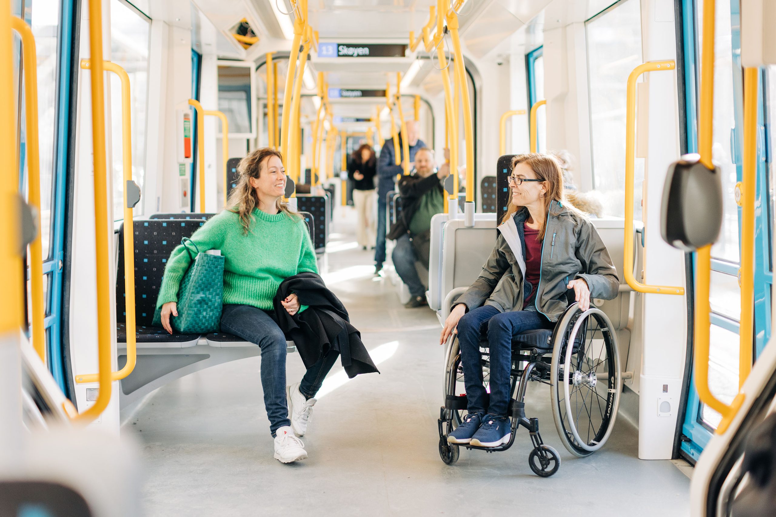 Two women inside the new subways. One of the women is in a wheelchair.