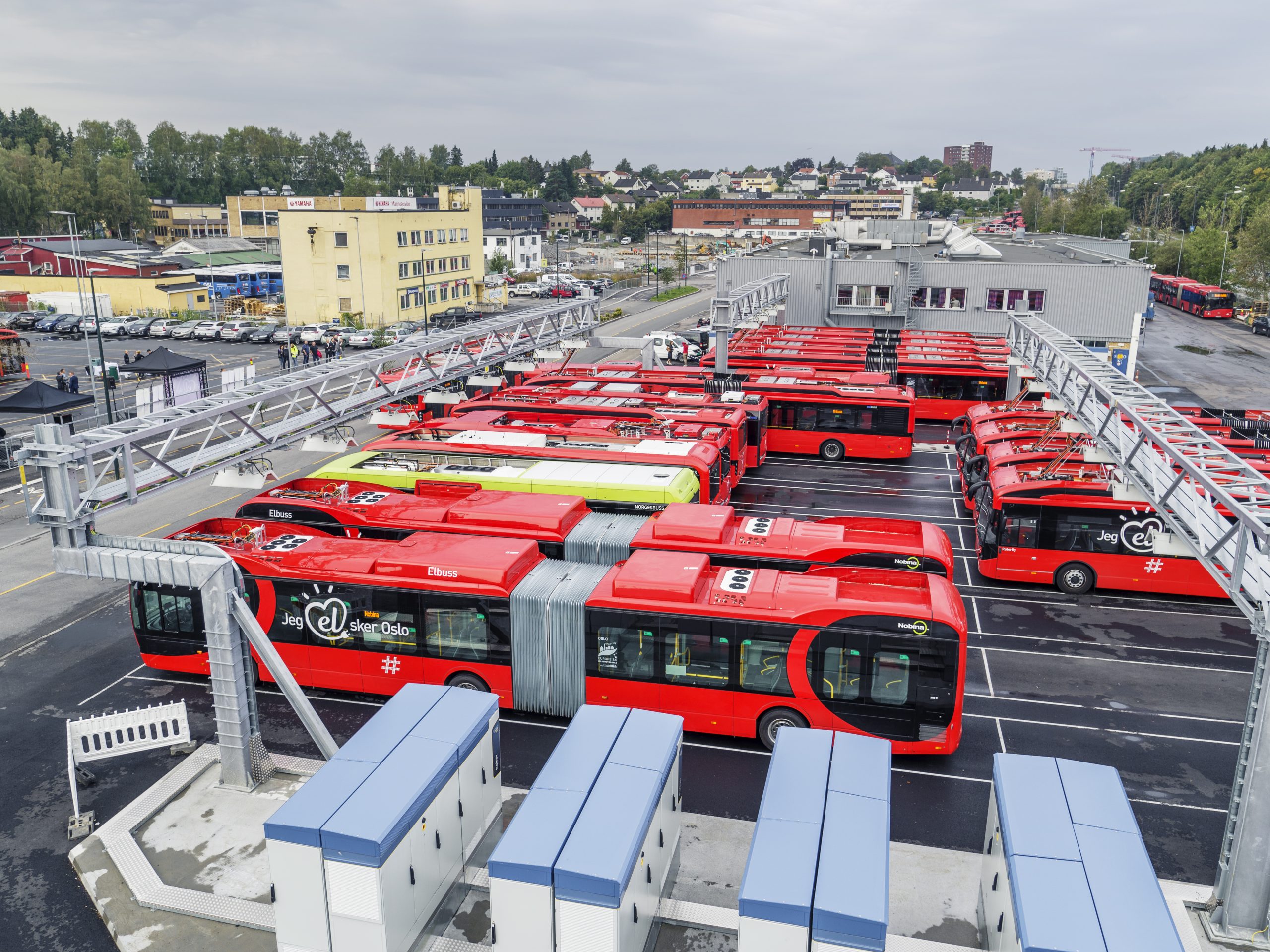 Electric busses parked and charging at a charging facility for busses in Oslo.